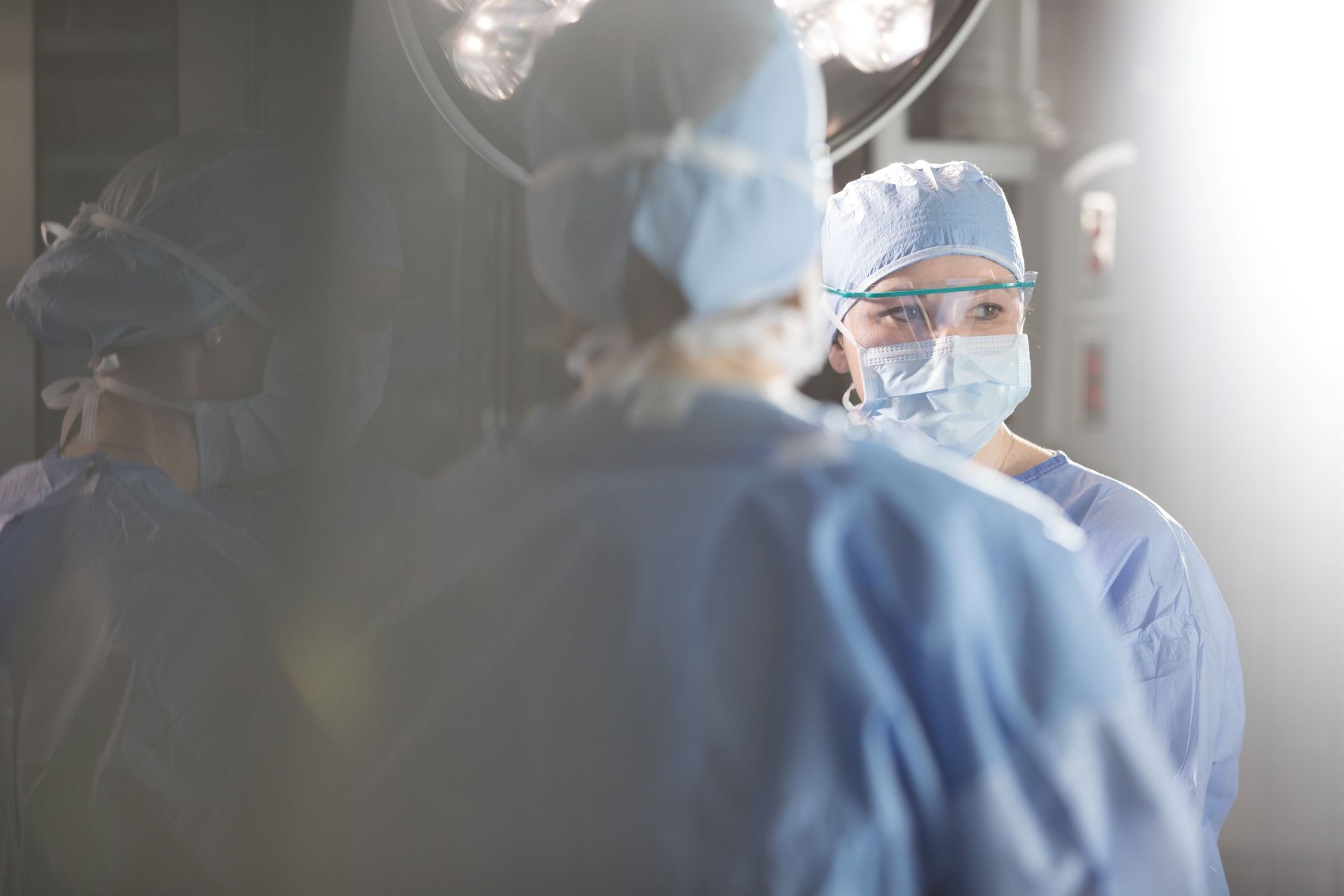 Physicians attend to a patient in a medical procedure. 