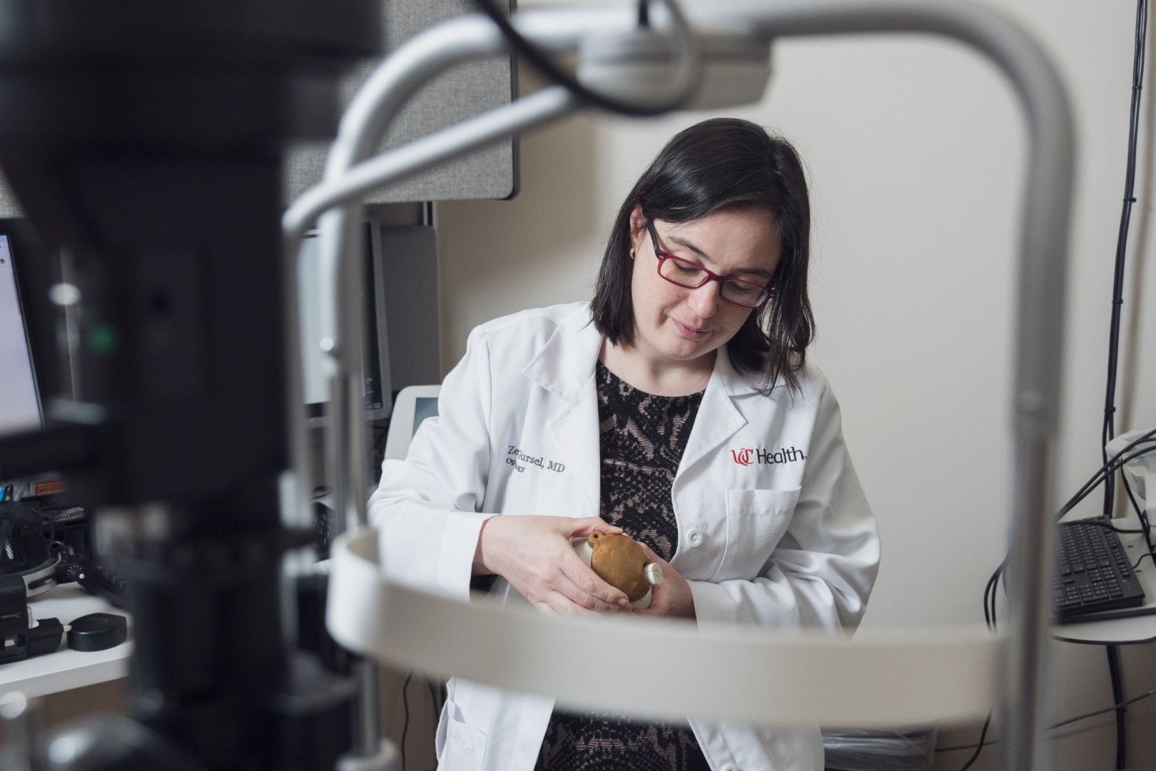 Physicians holds medical device related to eye care. 