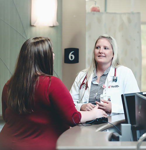 Physician talks with a patient in a medical office. 