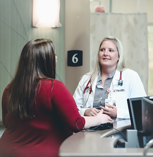 Physician talks with a patient in a medical office. 