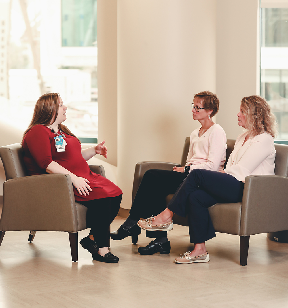 Physician talks with a patient and another person.