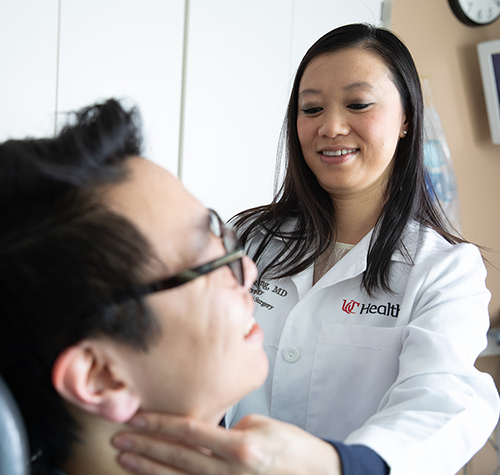 Physician examines a patient in a medical environment. 