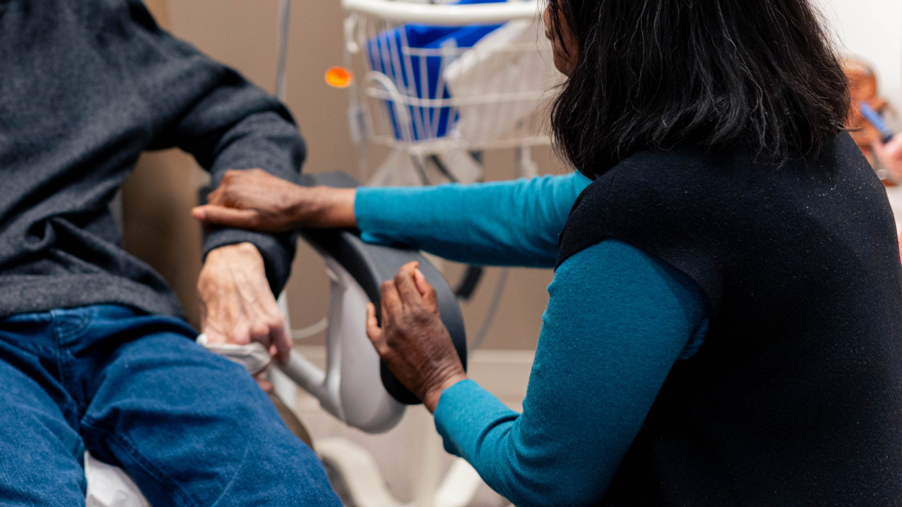 Patient holding hands with doctor