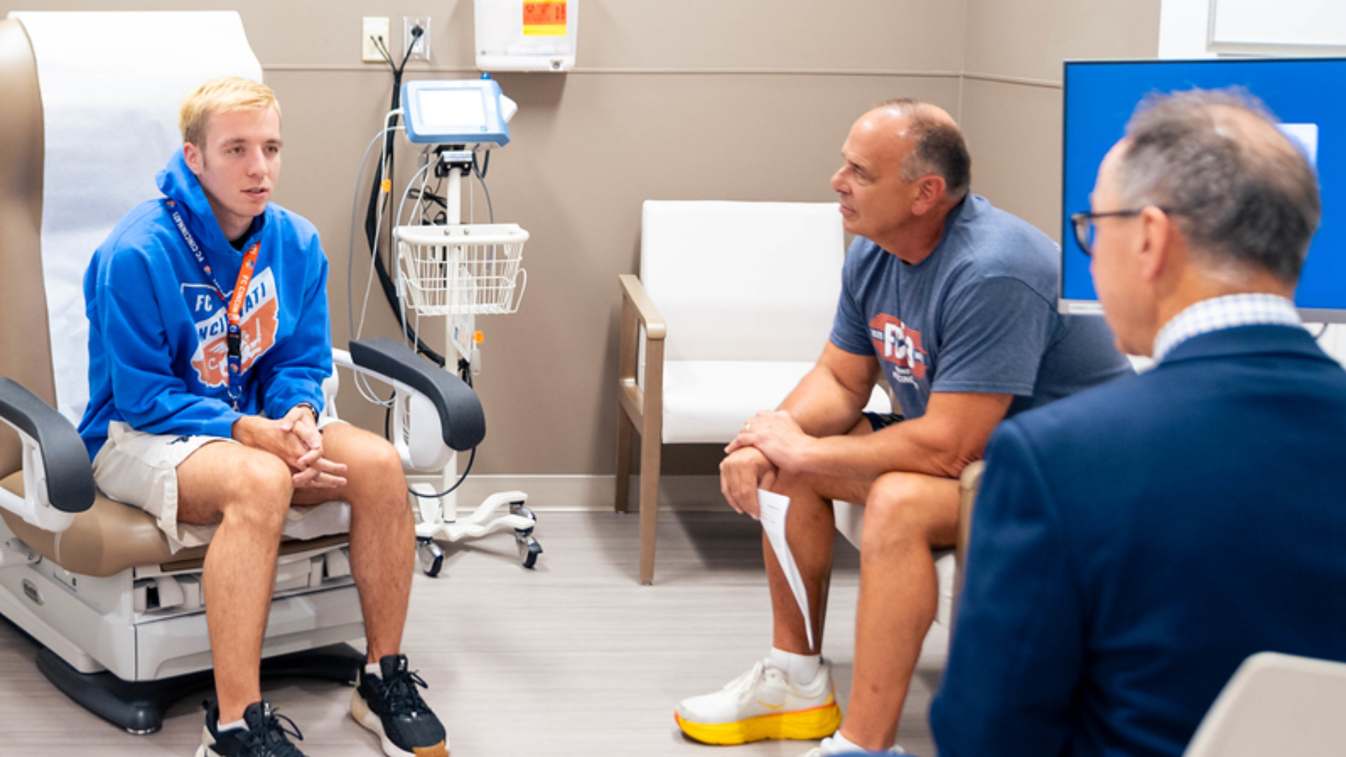 Patient and family meet with provider in medical office