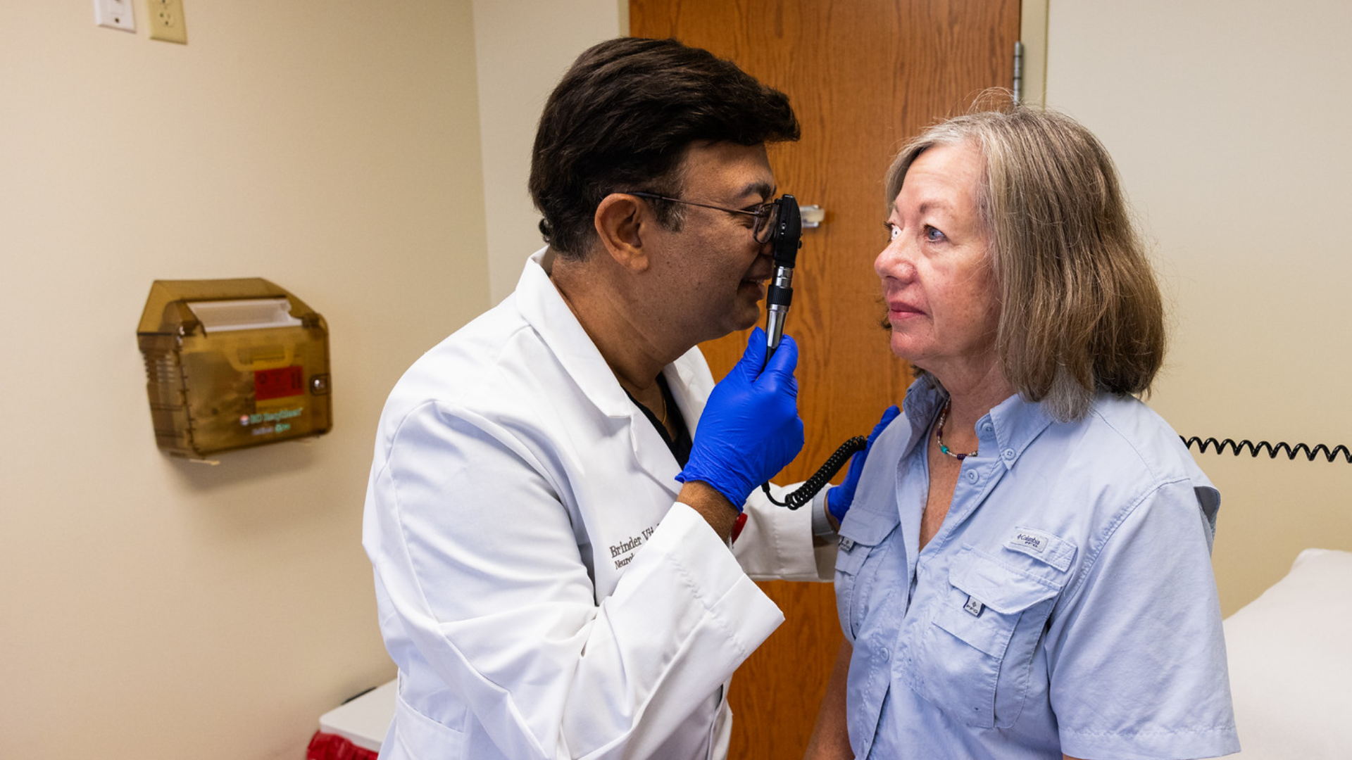Physician at UC Health using a neuromodulation device