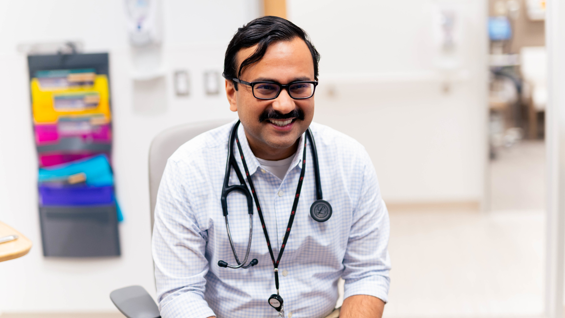 UC Health physician smiles during an appointment with a patient
