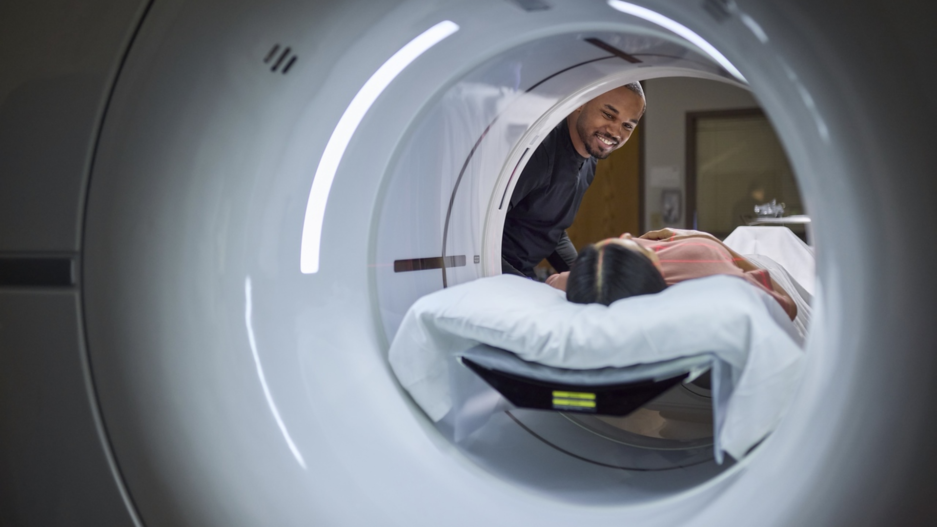 Provider attends to a patient in an imaging machine. 