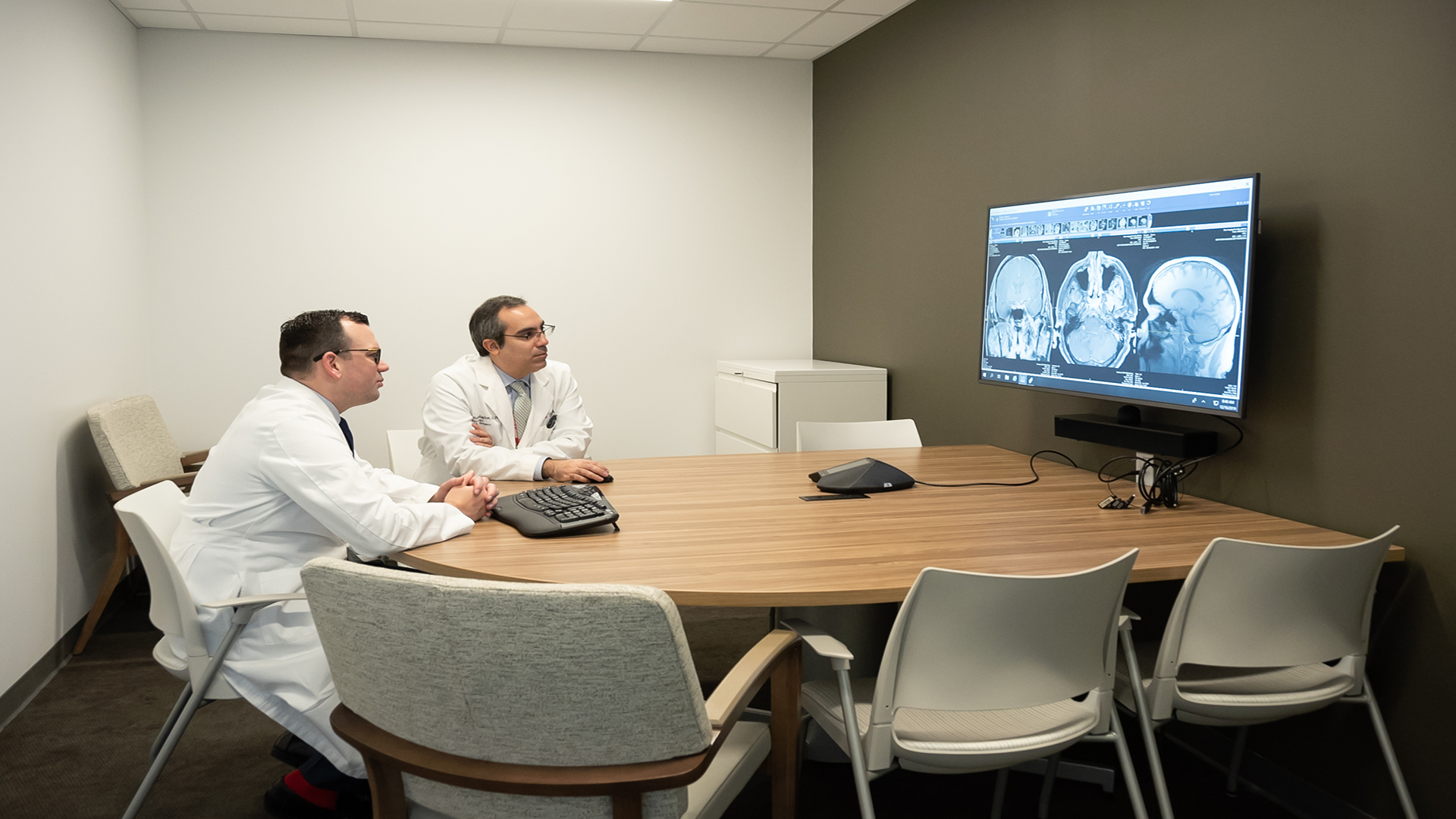 Physicians sitting at a table. 