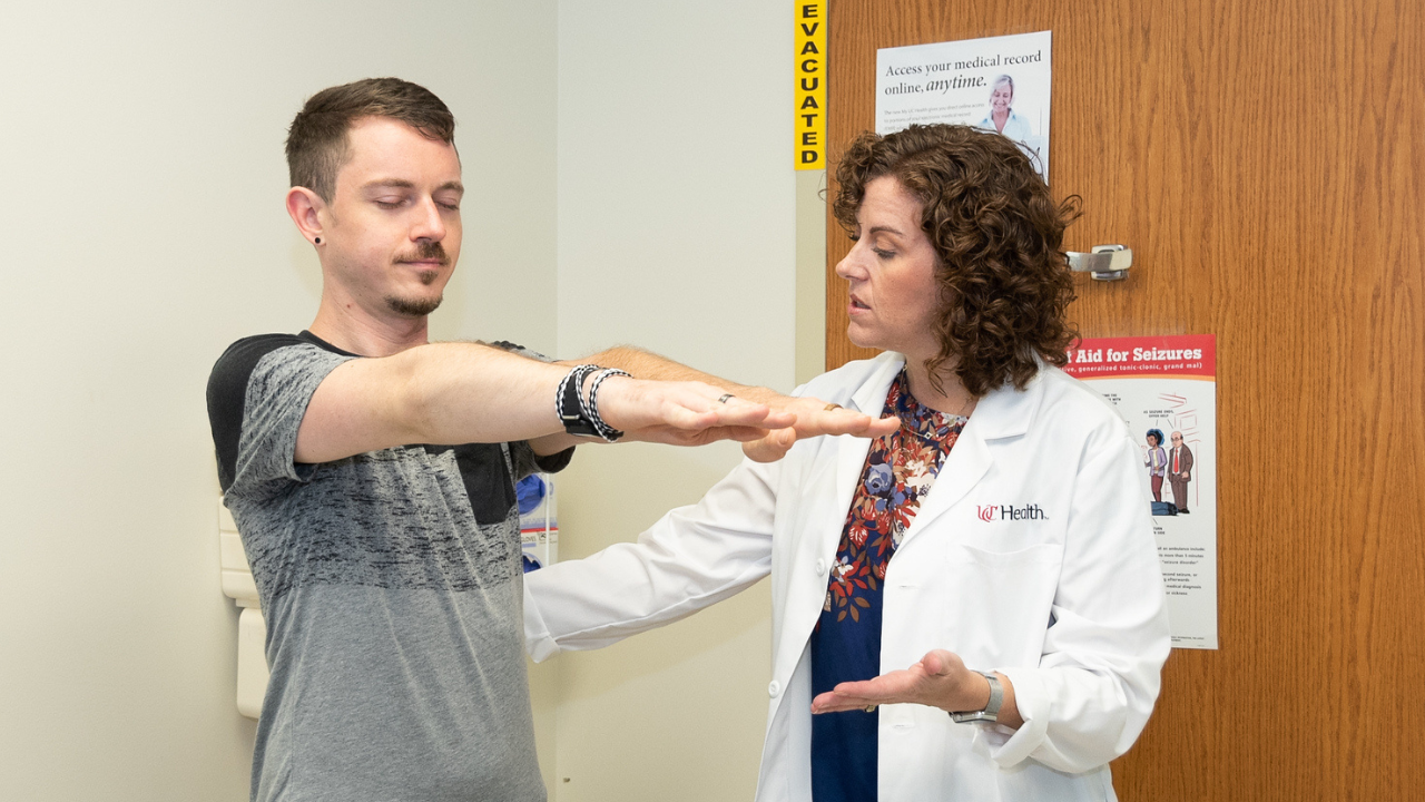 Physician helps a patient in a medical environment.
