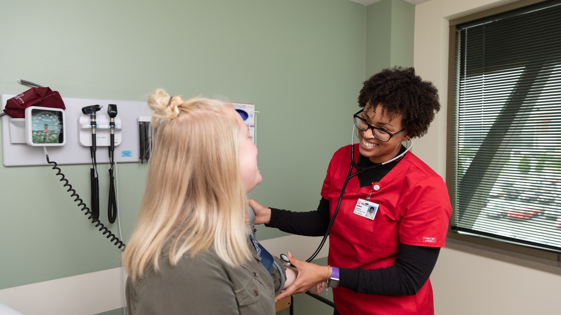 Physicians at UC Health in Cincinnati meet with a patient in an office