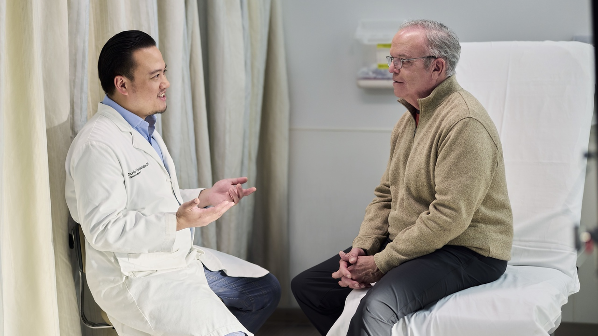 Physician talks with a patient in a medical environment. 