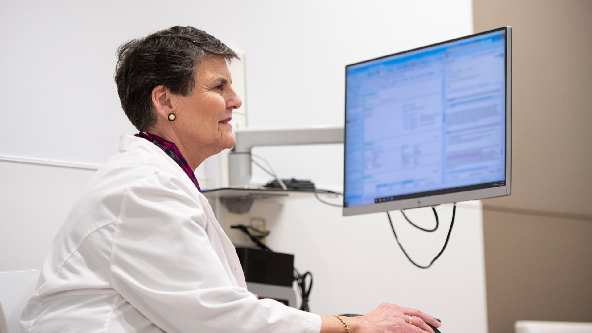 Physician works at a computer station. 
