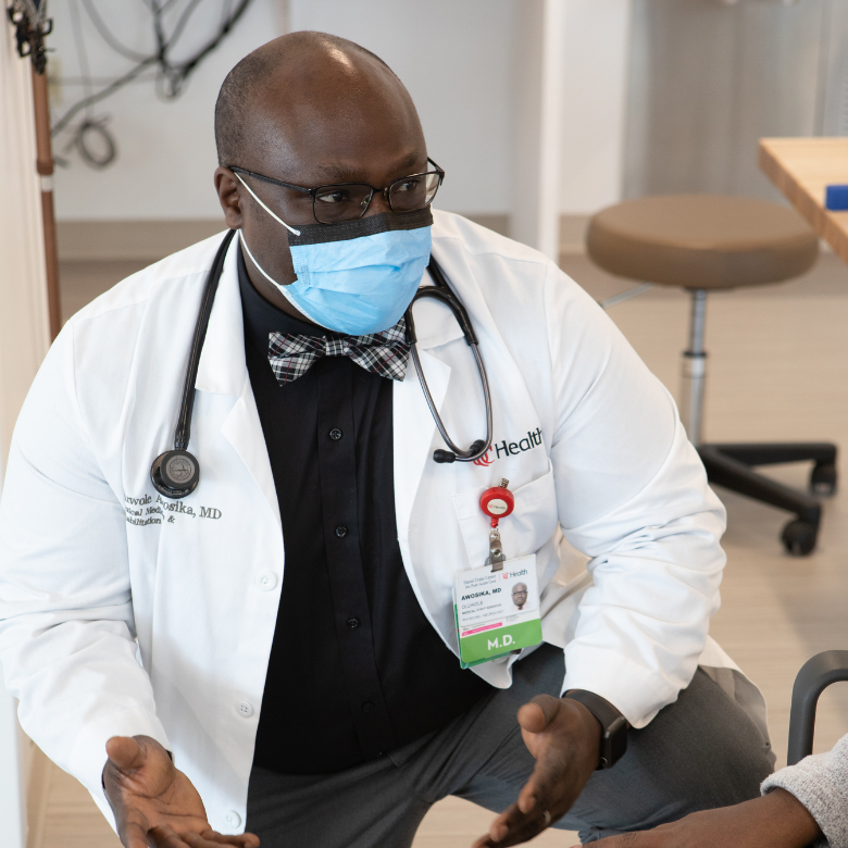 Physician attends to a patient's hands. 
