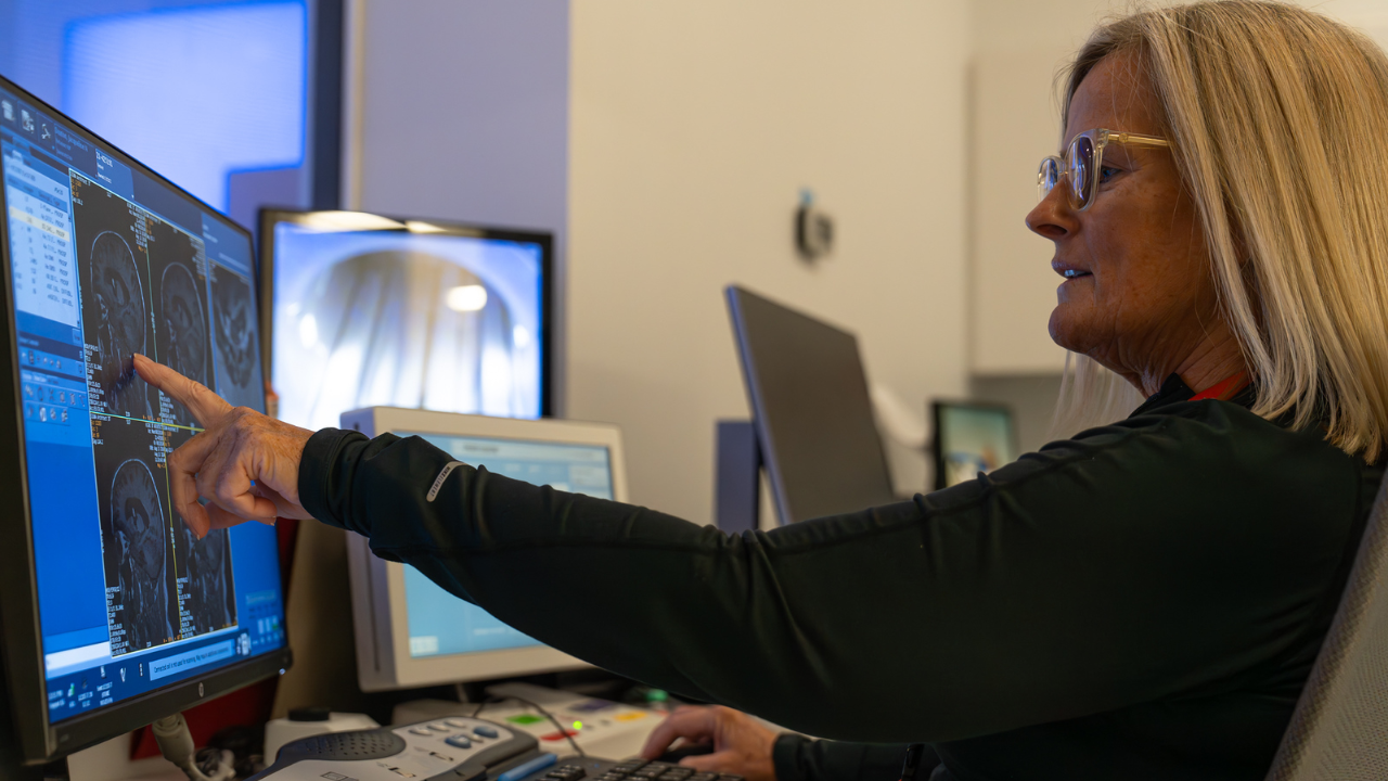 Researcher reviewing a brain MRI on a computer monitor at the University of Cincinnati Gardner Neuroscience Institute