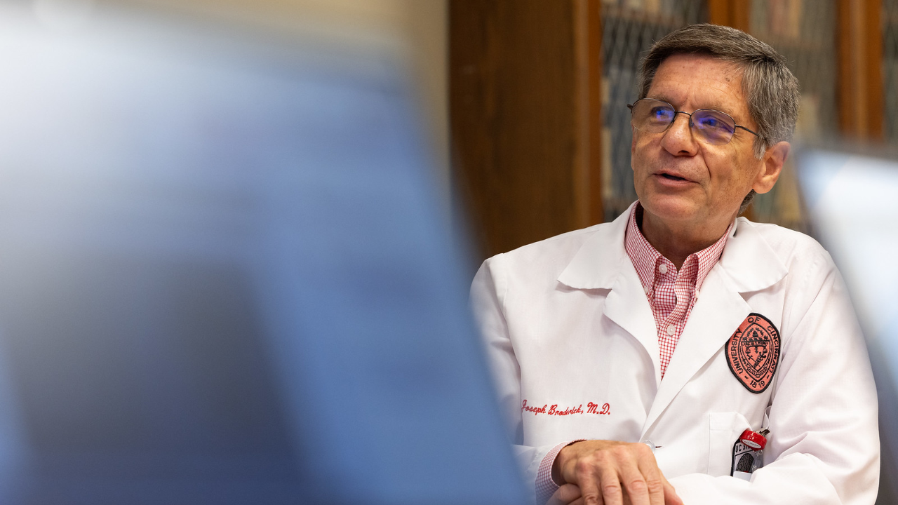 Dr. Joseph Broderick speaking in a conference room