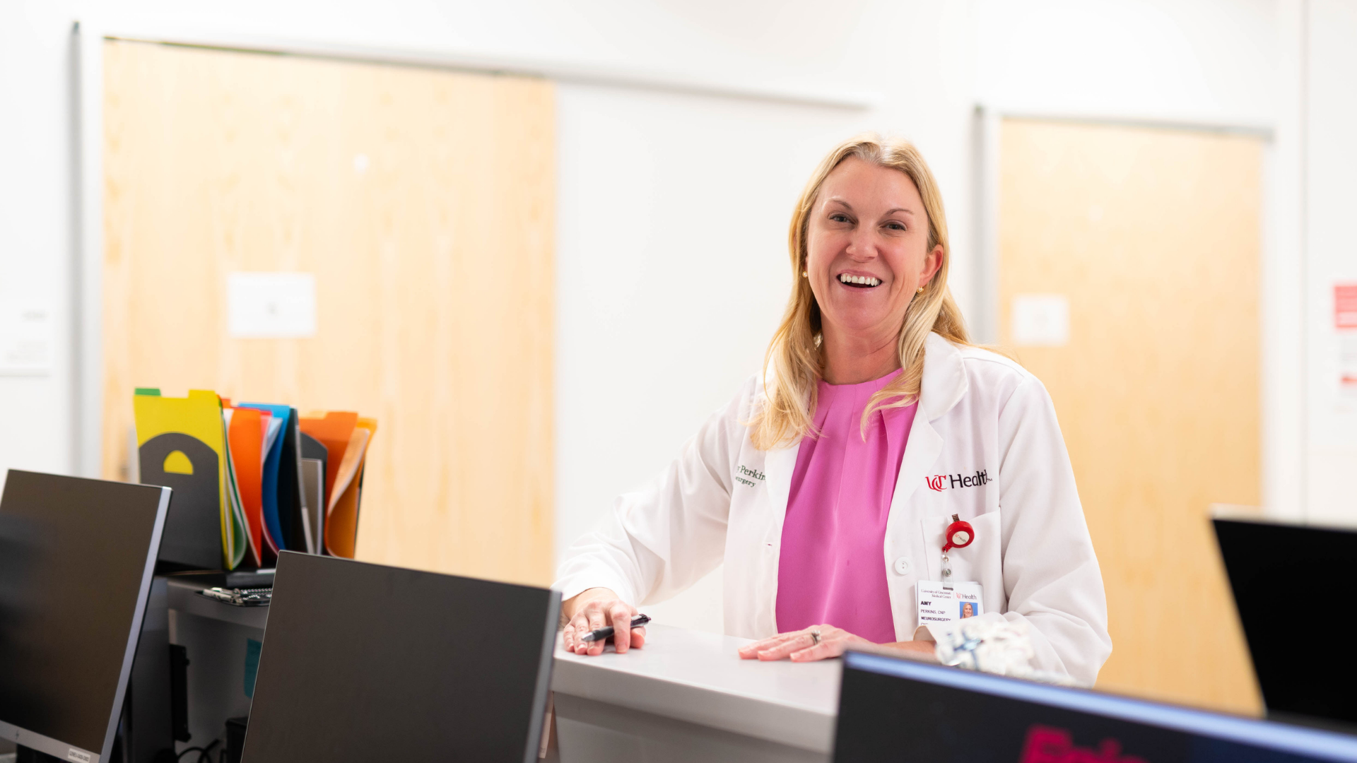 Nurse Practitioner stands at desk at Back, Neck and Spine Center in Cincinnati, Ohio