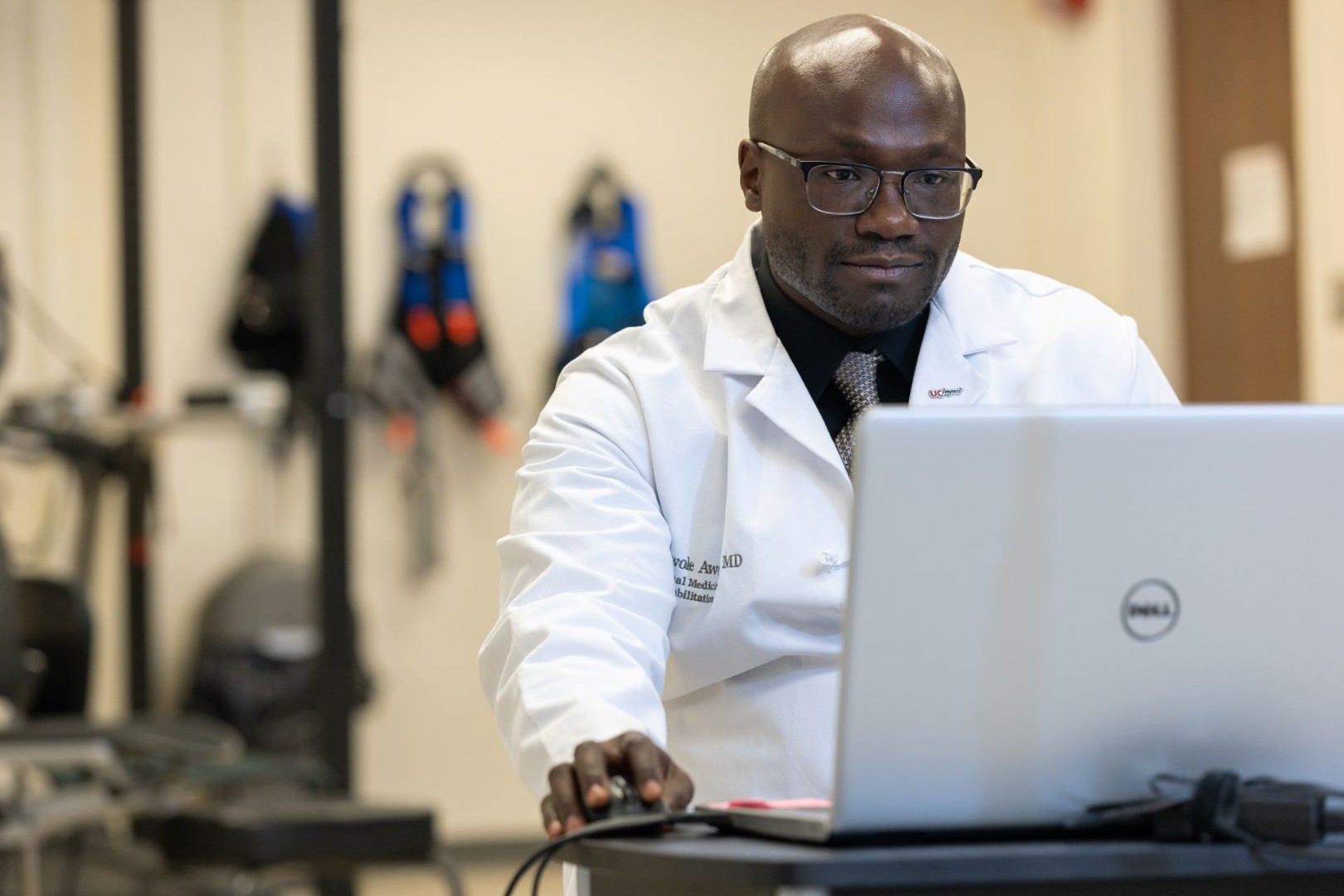 Dr. Awosika looks at a laptop. 