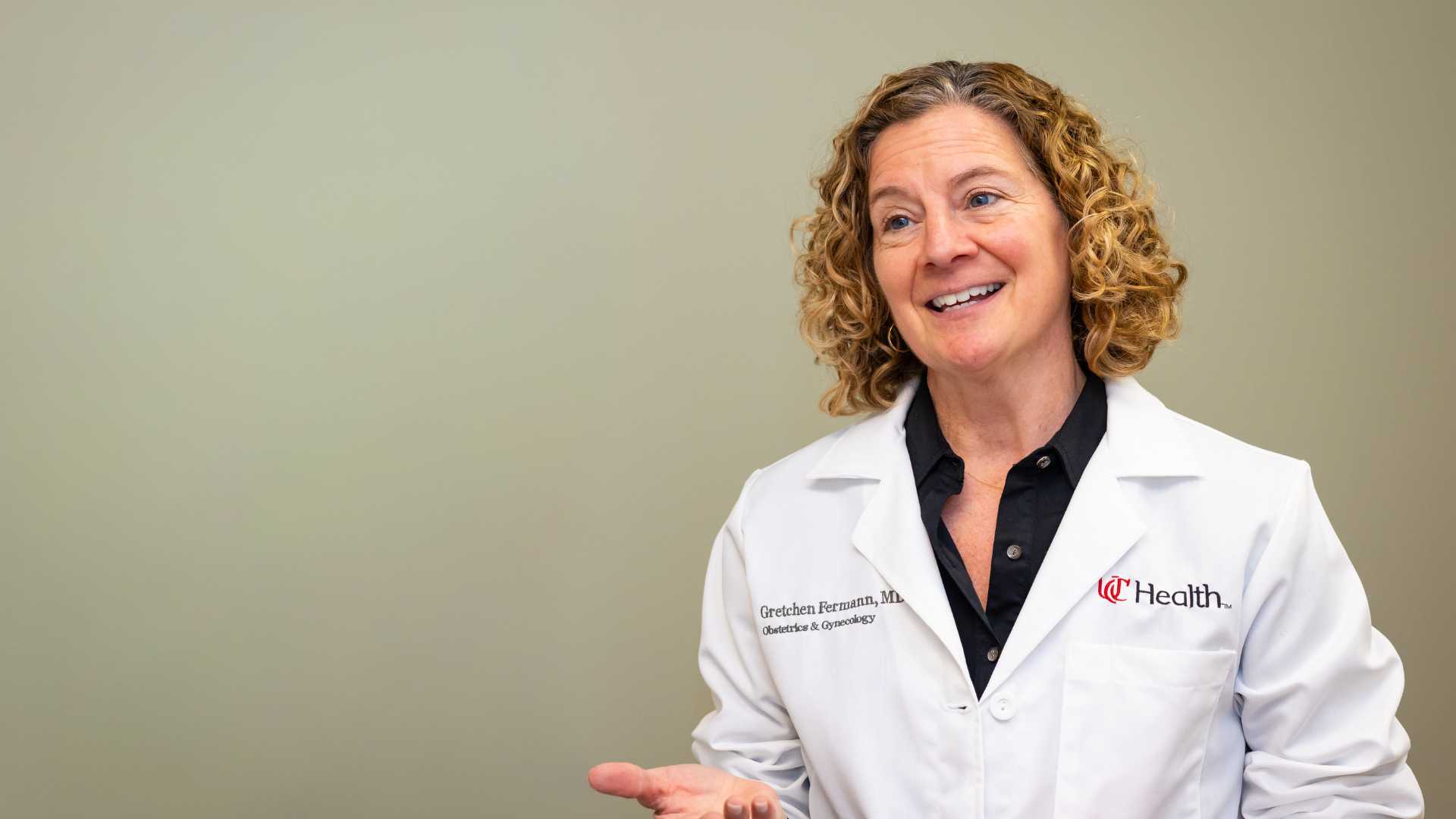 UC Health doctor smiles while speaking with patient