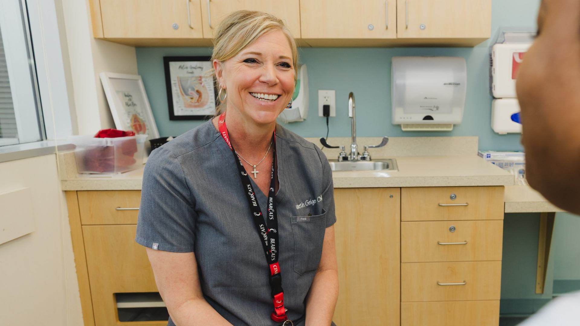 A medical provider smiles as she talks with a patient.