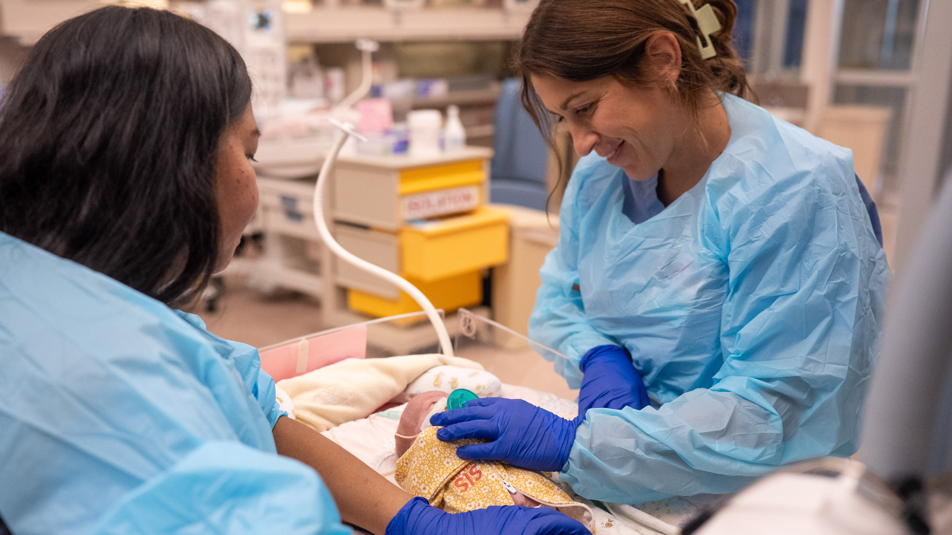 UC Health NICU care providers comfort a baby during an exam