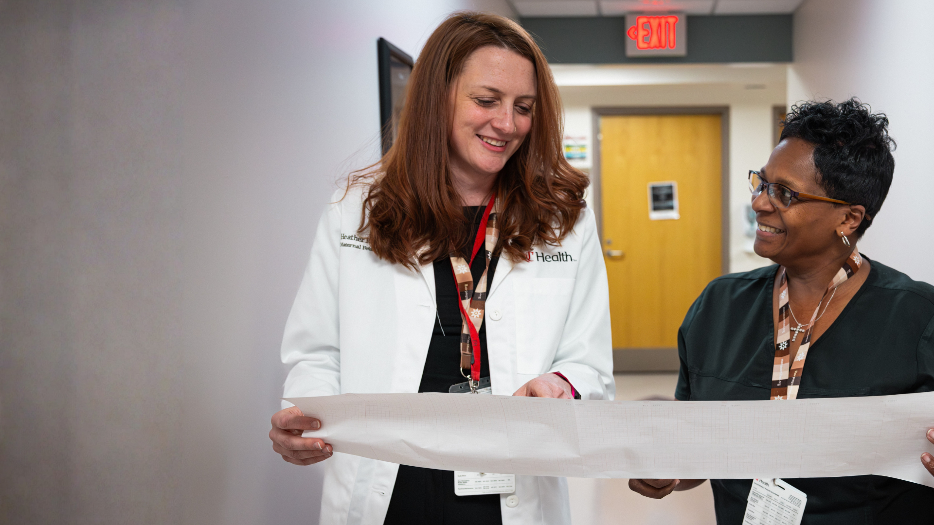 UC Health Women's care team members walk through a hallway together