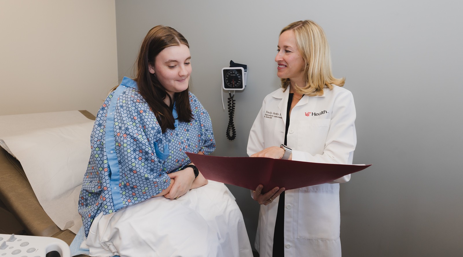 Physician talks with a patient in a medical setting.