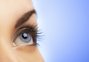 Human eye on blue background (shallow DoF)
